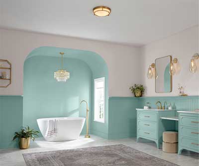2024 Color of the Year, Renew Blue, is featured in a large bathroom with two vanities and freestanding tub.