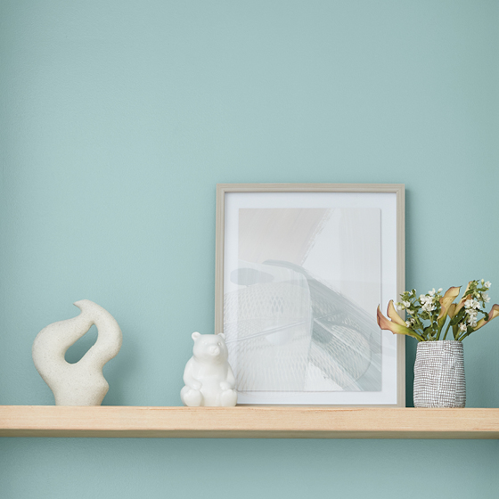 Light wooden shelf holds accessories chosen to express personal style. 