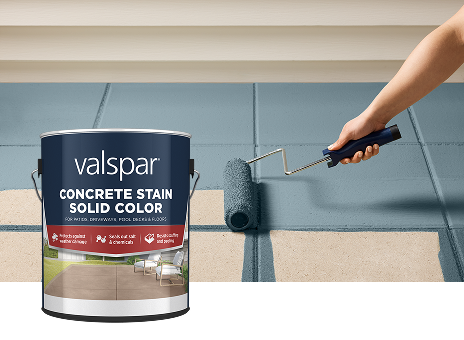 Valspar Solid Color Concrete Stain applied with a paint roller across a concrete surface, demonstrating decorative outdoor color enhancement.
