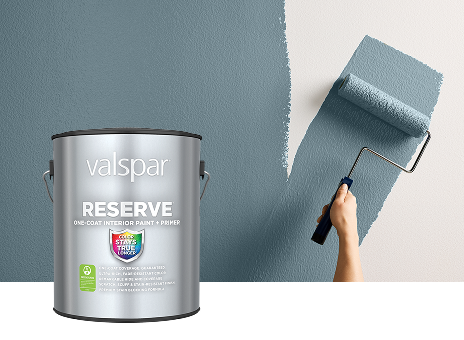 Valspar Reserve Interior Paint + Primer can displayed beside a paint roller coated in Cottage Door paint, showcasing premium interior application.
