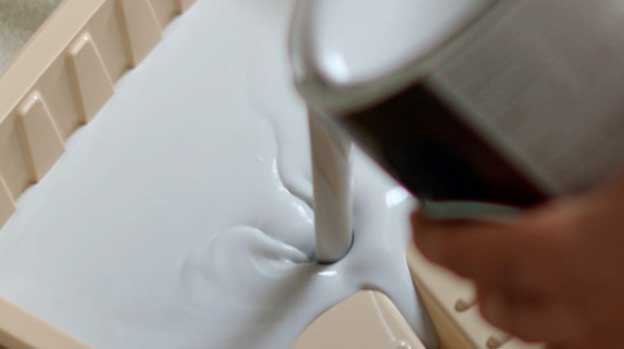 Close up of paint being poured into a tray.
