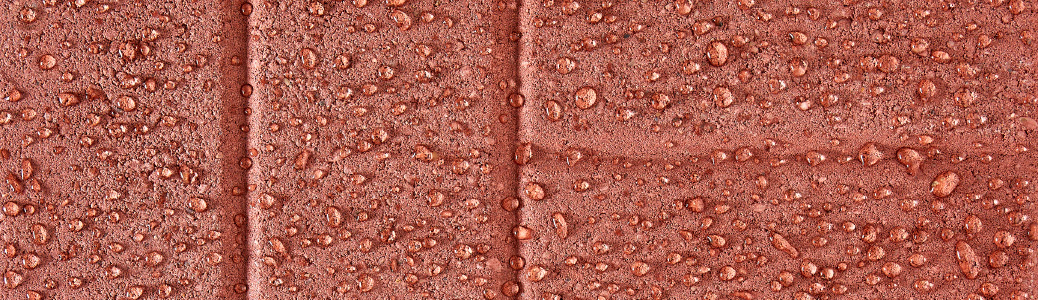 Red bricks with waterdrops formed on top.