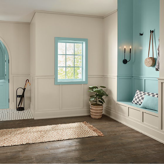 Elegant minimalistic entry hall uses trending color on trim and niches only. 
